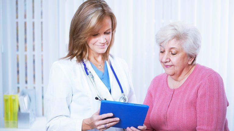 Physician and patient looking at tablet